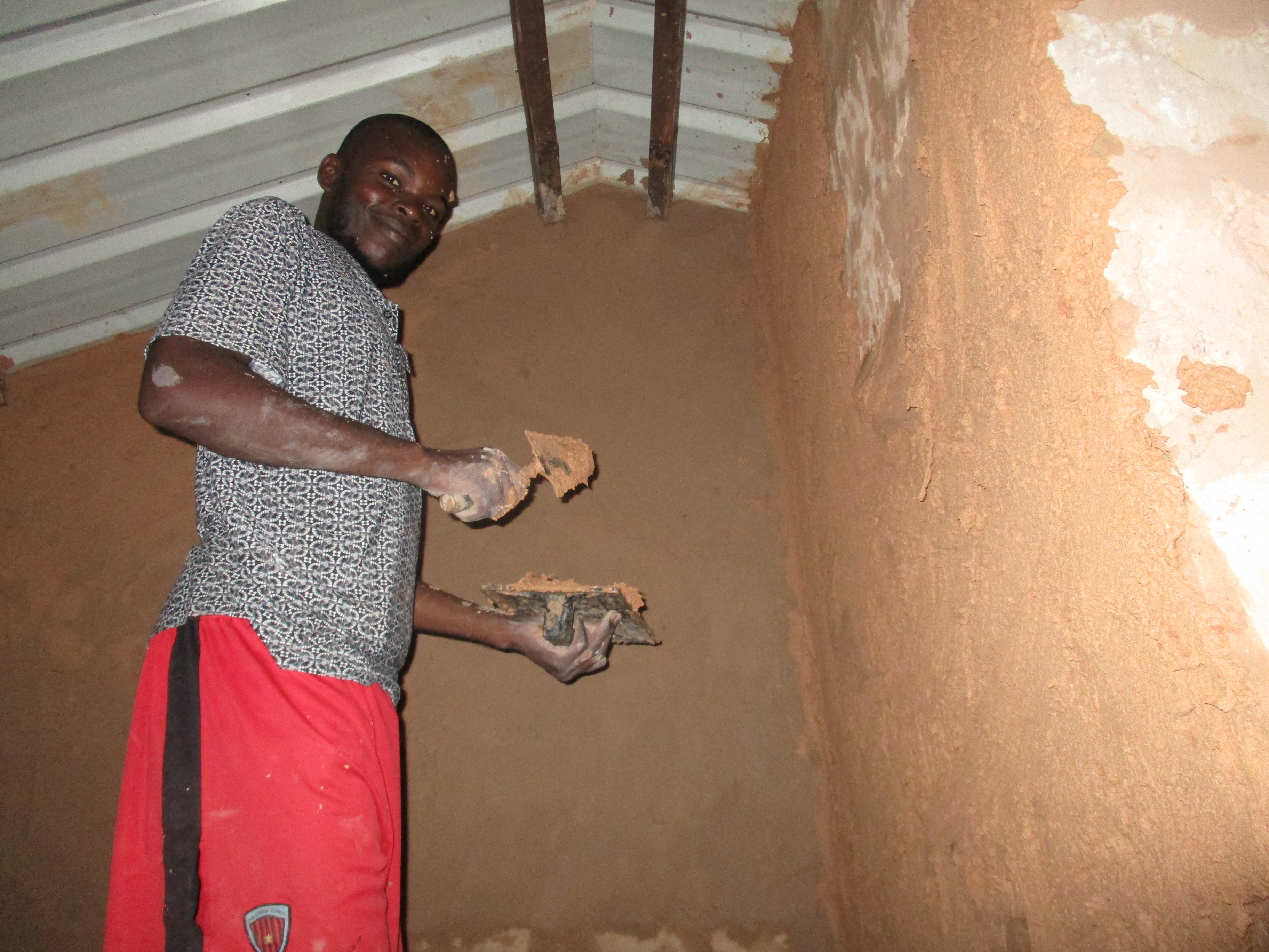 Luca working on the wall up on a scaffold