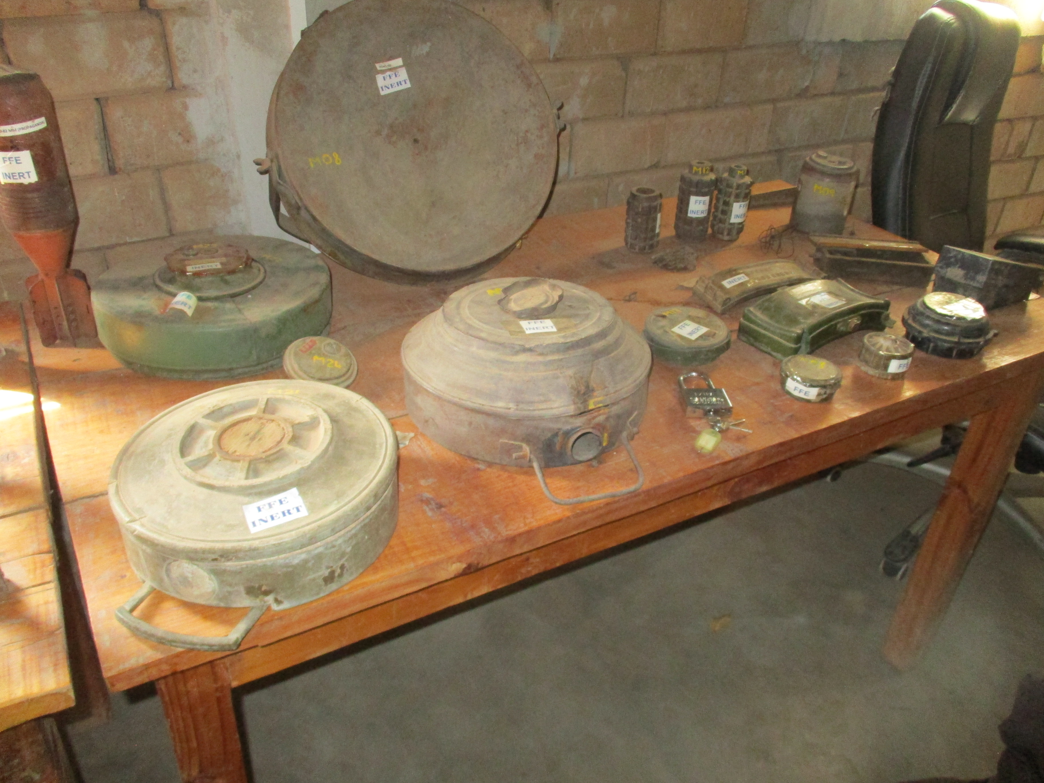 HALO Trust Menongue collection of unexploded ordnance. Big and small landmines and claymores on a table