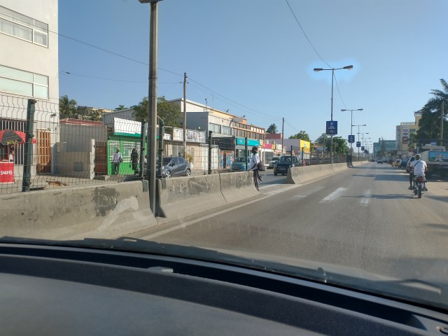 Two lane road divided by thin concrete barrier for median
