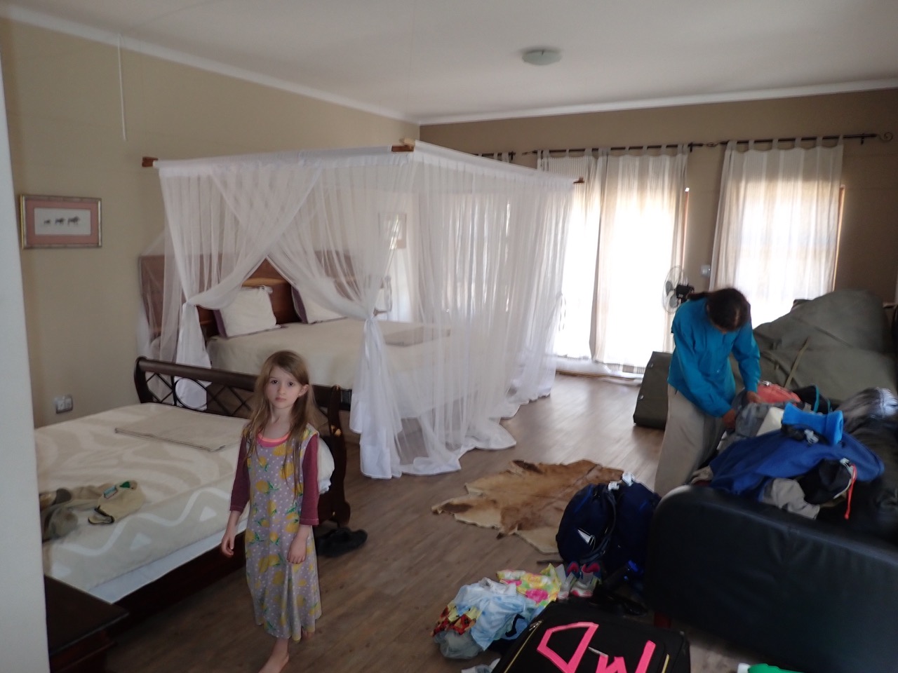 woman and girl in the main bedroom of uncharted safaris lodge in menongue angola