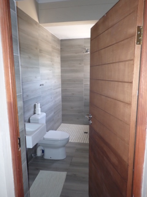 tiled bathroom with walk in shower at uncharted safaris lodge in menongue angola