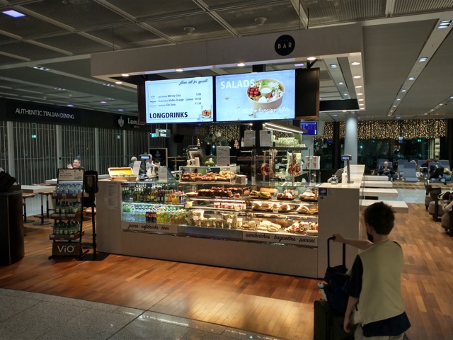 boy at a deli store at the airport