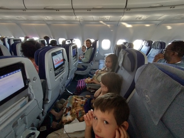 a family sits in their airplane seats