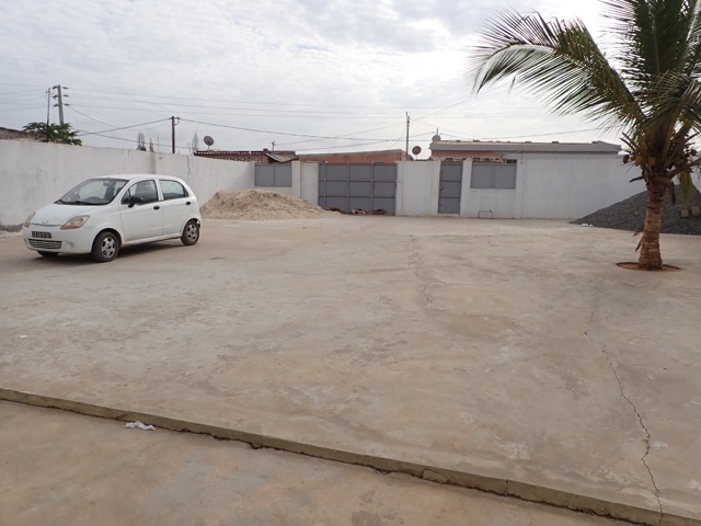 concrete front yard of walled compound