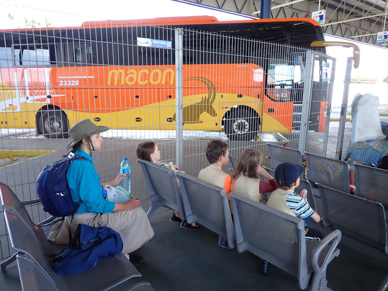 family waiting in front of a bus in luanda angola