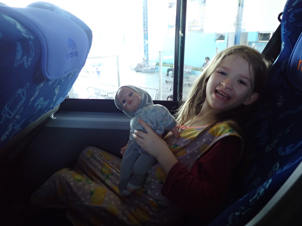 girl and doll on a bus
