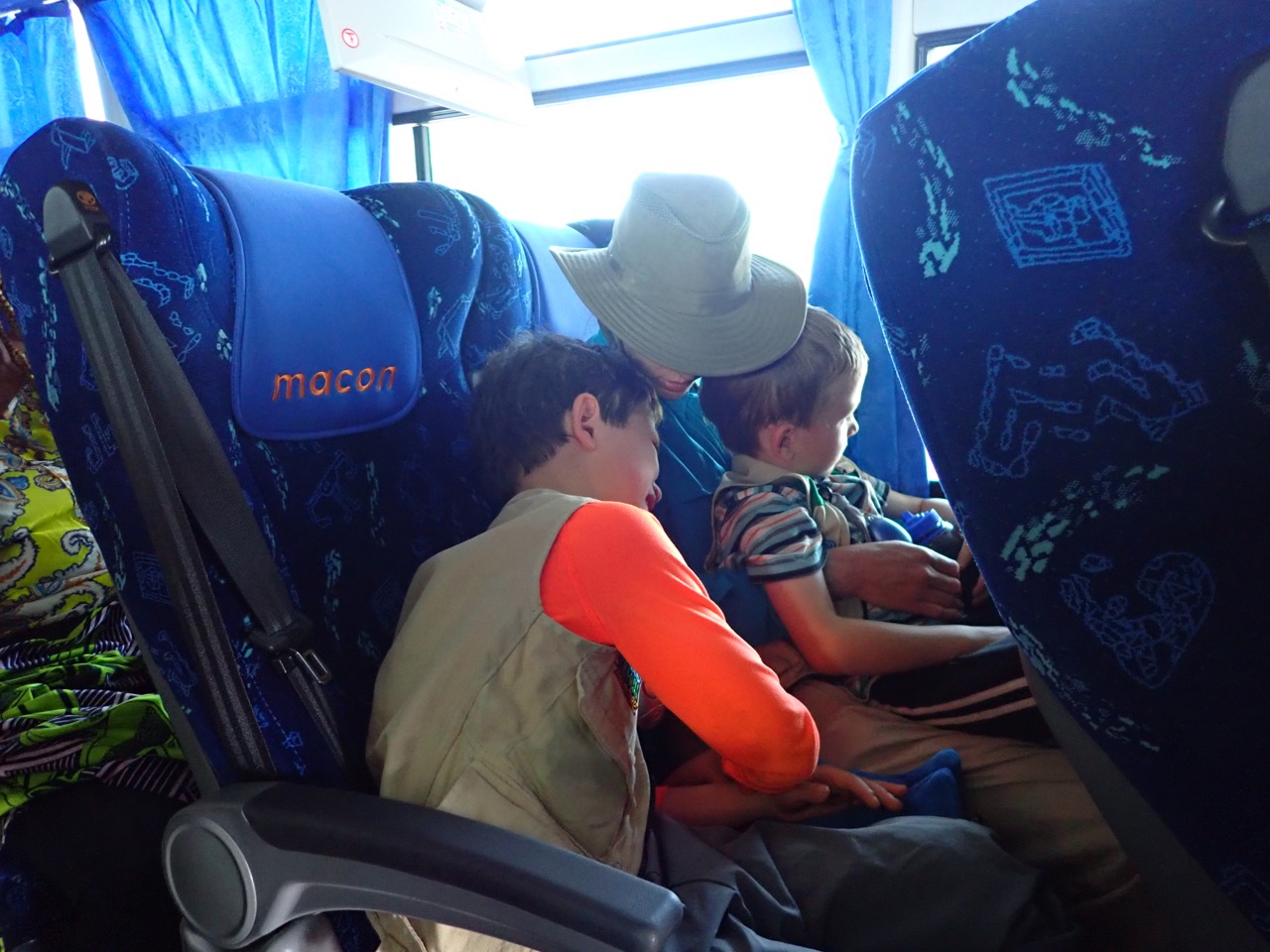 boys and mother in bus seat
