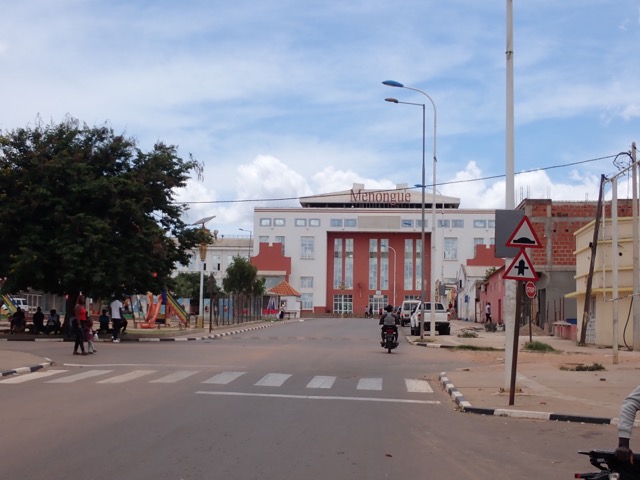 a road with a train station in the distance