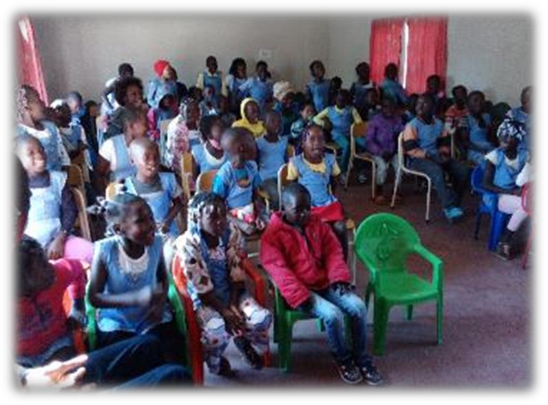 children in chairs in a schoolroom
